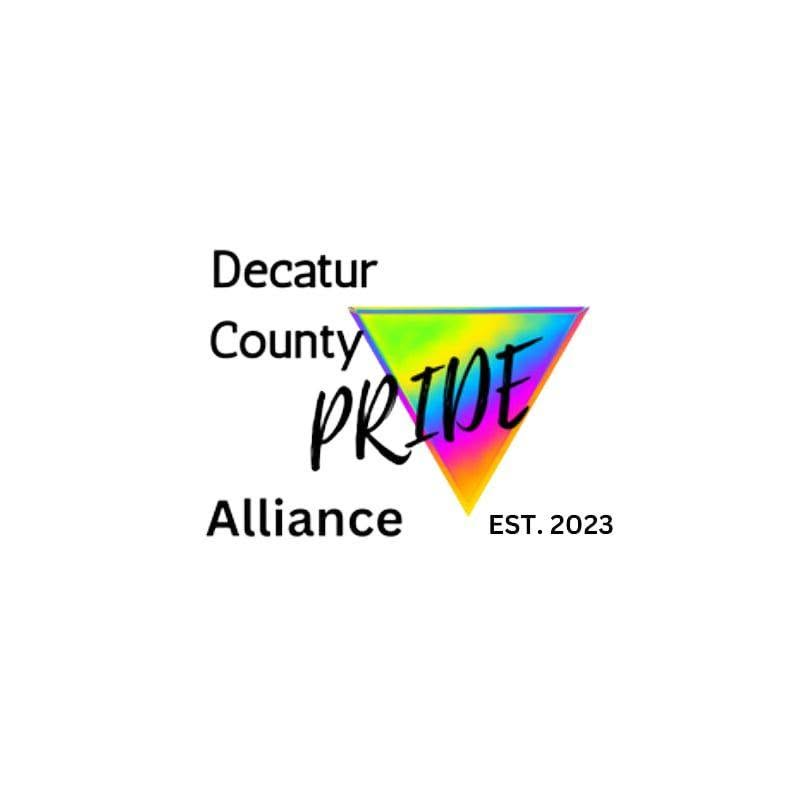 The Decatur County Pride Alliance logo, the logo says "Decatur County" in a black sans serif font, "PRIDE" in a black script font, then "Alliance" in a black sans serif font. The year the group was founded is displayed as "Est. 2023" in a black sans serif font next to the word "Alliance." There is a rainbow colored equilateral triangle behind the word "PRIDE." Logo created by Tammi Bailey.